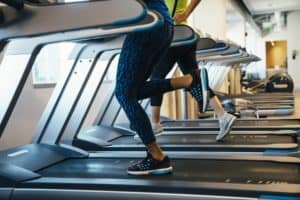 women running on treadmill after drinking best BCAA